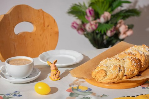 Breakfast table with coffee, yeast braid and decoration for Easter