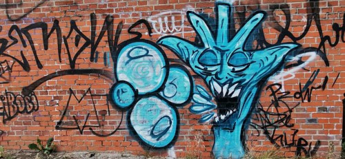 Creative graffiti on a brick wall in shades of blue, Olsztyn, Masuria, Poland