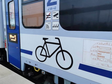 Side view of a train with bicycle symbol and blue paint, Polish bicycle compartment, cycling in