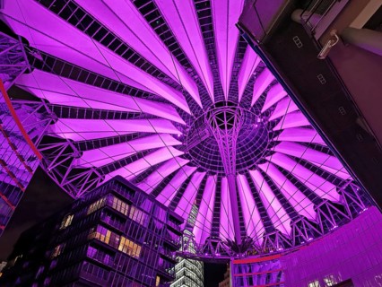 Illuminated roof of the Center am Potsdamer Platz in Berlin in bright pink, with futuristic design,