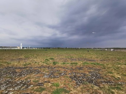 Cloudy sky over a wide field with flying dragons, Tempelhofer Feld in autumn, Berlin