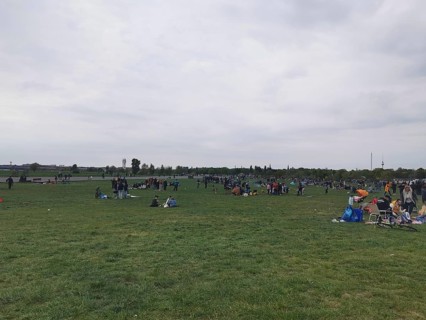 Extensive Tempelhofer Feld with people enjoying free time on a large meadow, Berlin
