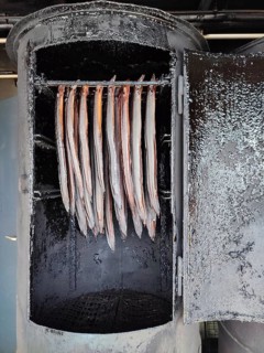 Smoker with hanging fish in a traditional cooking environment, Berlin