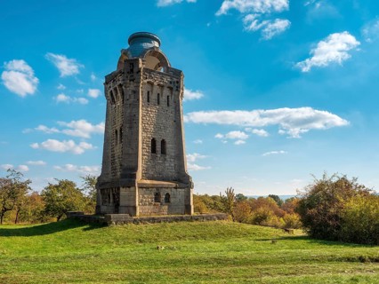 The Bismarck Tower at Großer Fallstein in autumn under a blue sky with fair weather clouds,