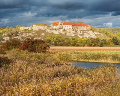Wendelstein Castle above the Unstrut near Memleben in autumn under dark clouds, reeds in autumn