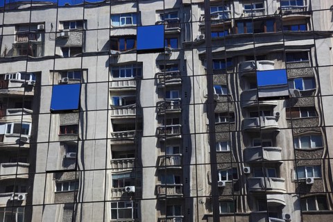 Romania, capital city Bucharest, Bucuresti, reflection in a glass façade