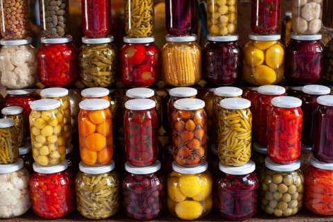 Brightly colored jars of Turkish Tursu, pickled vegetables for sale in an Istanbul Bazar, Turkey