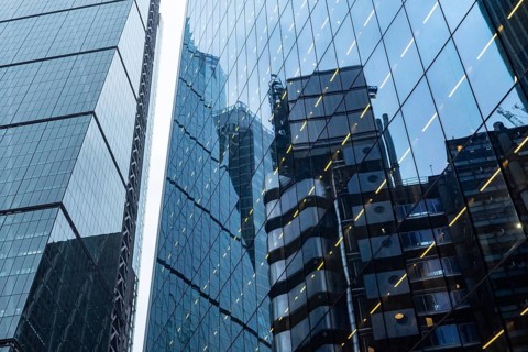 Modern abstract reflections in glass fronted commercial office buildings in the financial district