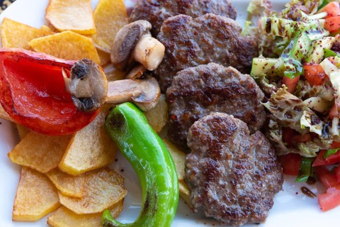 Alanya, Turkey. April 7th 2021 Typical Turkish meal of Kofte with green pepper, mushroom, salad and