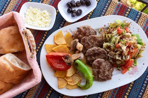 Typical Turkish meal of Kofte with green pepper, mushroom, salad and French fries