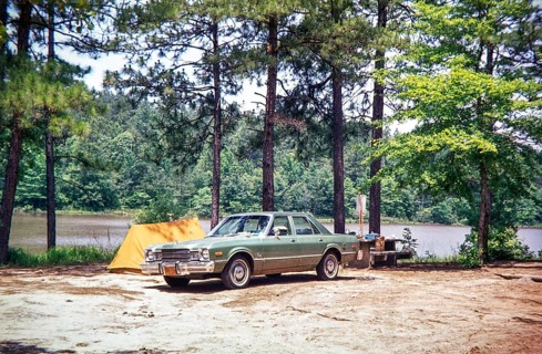 1976 Plymouth Volaré car automobile parked on campsite next to small two-man tent, USA 1976