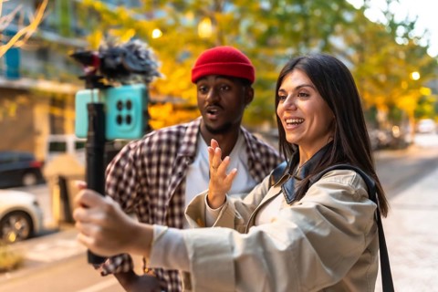 Happy young multiracial couple creating social media content, live streaming, and recording video