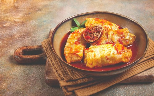 Stuffed cabbage rolls with minced meat, in tomato sauce, top view, without people, in the spotlight