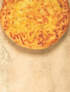 Khachapuri in Megrelian, a traditional Georgian dish, flatbread with cheese, top view, no people