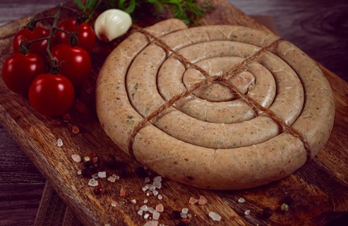 Raw spiral sausages, on a wooden board, top view, no people