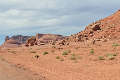 Barren desert landscape with red rock formations and sparse vegetation, Grand Canyon National Park,