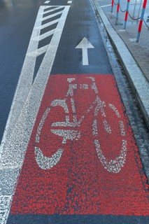 Red marked bicycle path on the road, Krakow, Poland