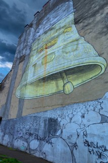 Wall painting of a bell on a house wall, Krakow, Poland