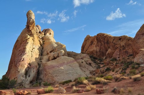 Dramatic sandstone cliffs rise into the sky under bright sunshine and blue skies, Valley of Fire