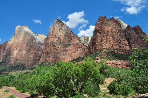 Impressive red rock formations against blue sky and green trees, Zion National Park, Utah, USA