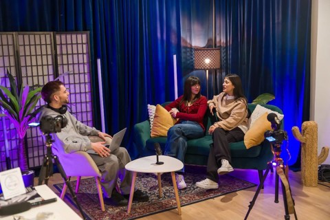 Young multiethnic creators collaborating on a podcast and social media video in a modern studio