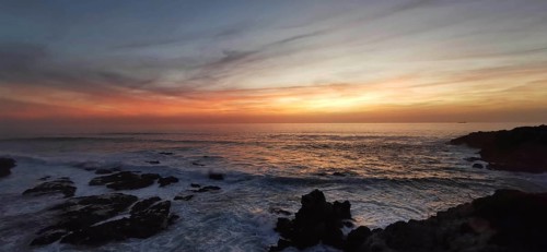 Calm sunset over the sea, soft colors in the sky and views of rocks, hiking on the Fisherman's