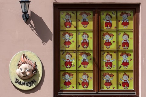 Window of a toy store covered with children's comics, Lviv Ukraine