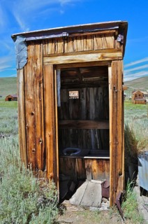 An old, rustic wooden cabin, toilet, outhouse, in historic construction in a rural area, Bodie