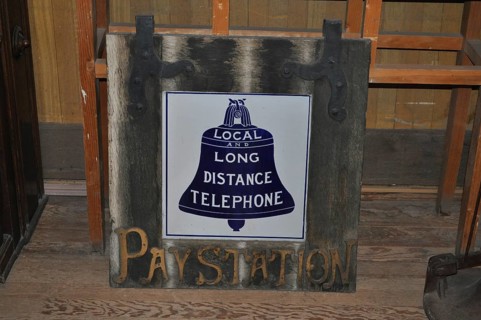 A historic telephone sign on a wooden board in an abandoned room, Bodie Ghost Town, California, USA