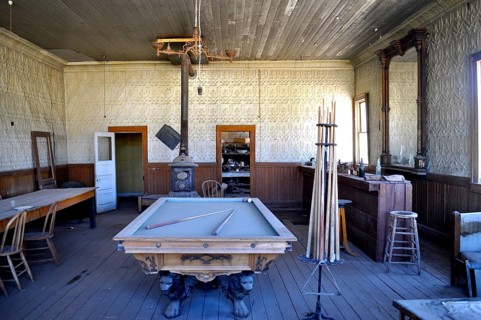 An abandoned billiard room in a saloon with antique rustic decor and wooden furniture, Bodie Ghost