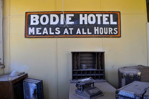 Sign of an old hotel with antique objects such as a typewriter, Bodie Hotel, Bodie Ghost Town,