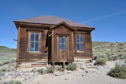 Ruined wooden house in a ghost town surrounded by arid countryside, Bodie Ghost Town, California,