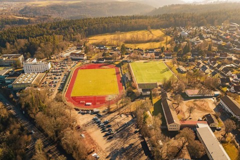 Extensive aerial view of an urban area with sports facilities and woodlands, Wimberg, Calw, Germany