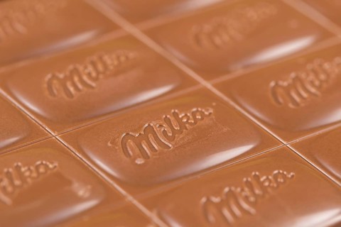 Milka chocolate bar alpine milk chocolate background with logo in Stuttgart, Germany