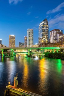 Tampa skyline with skyscrapers and bridge over Hillsborough River at night in downtown Tampa, USA