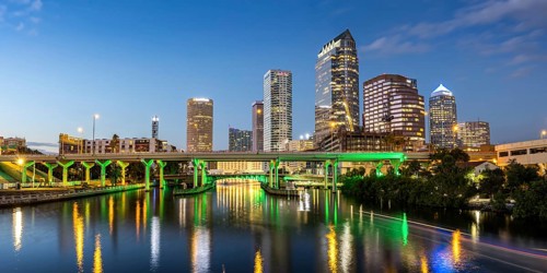 Tampa skyline with skyscrapers and bridge over Hillsborough River panorama at night in downtown