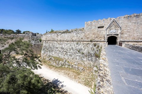Red gate from the Middle Ages in the city wall of the historic old town on the island of Rhodes,