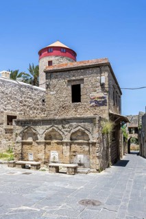 Ottoman fountain and windmill in the historic old town from the Middle Ages on the island of