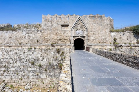Red gate from the Middle Ages in the city wall of the historic old town on the island of Rhodes,