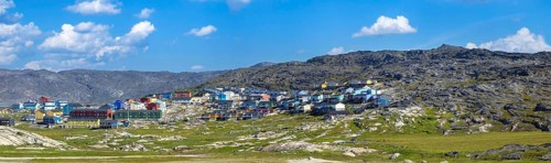 Typical architecture of Greenland Ilulissat with colored houses located near fjords and icebergs