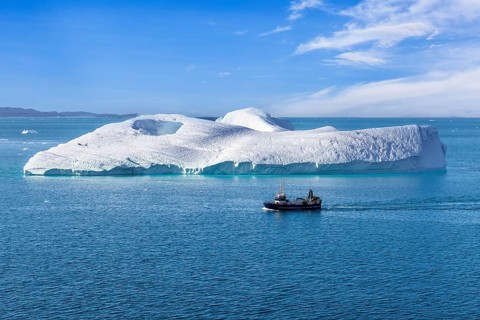 Iceberg seen from cruise ship vacation near Greenland coast in Arctic circle near Ilulissat Disko
