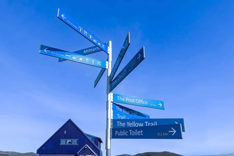 Greenland Ilulissat signs that show location of Ilulissat city and services