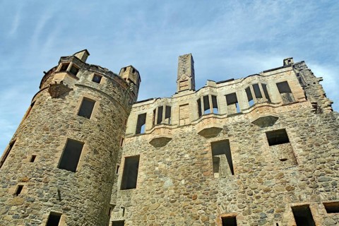 Stone castle ruins with old towers and windows under a clear blue sky, Huntly Aberdeenshire,