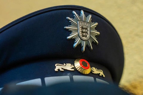 Close-up of a police cap with crest and blue fabric