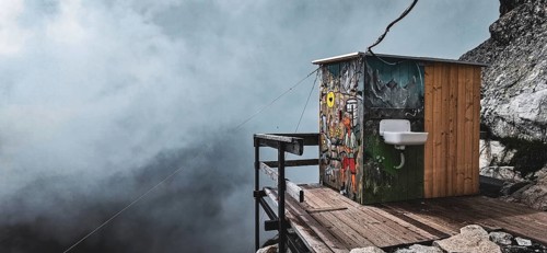 Colourful toilet at the Chata pod Rysmi mountain hut on a wooden platform in the middle of a