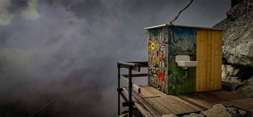 Colourful toilet of the Chata pod Rysmi mountain hut on a wooden platform in the middle of a