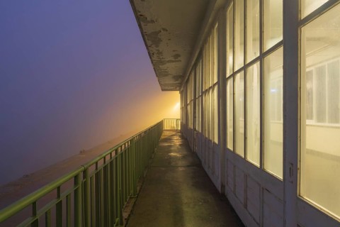 View along a long balcony of Steubenhöft at night in fog, Cuxhaven, Lower Saxony, Germany