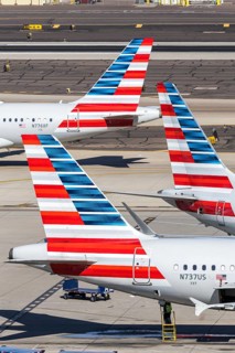 Boeing and Airbus aircraft tail units of American Airlines with the license plate N737US at Phoenix