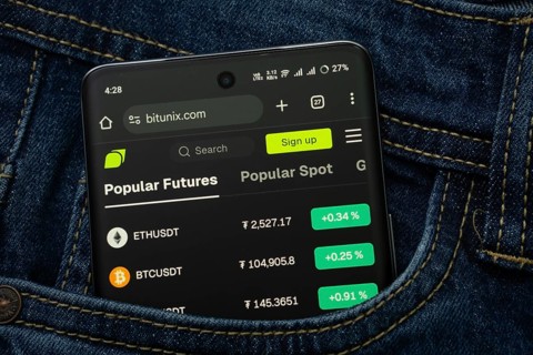 Dhaka, Bangladesh- 15 June 2025: A smartphone displaying the Bitunix.com web interface peeks out of