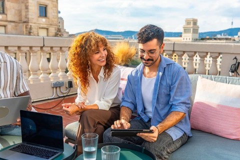 Two diverse colleagues collaborating during an outdoor business meeting on a professional coworking